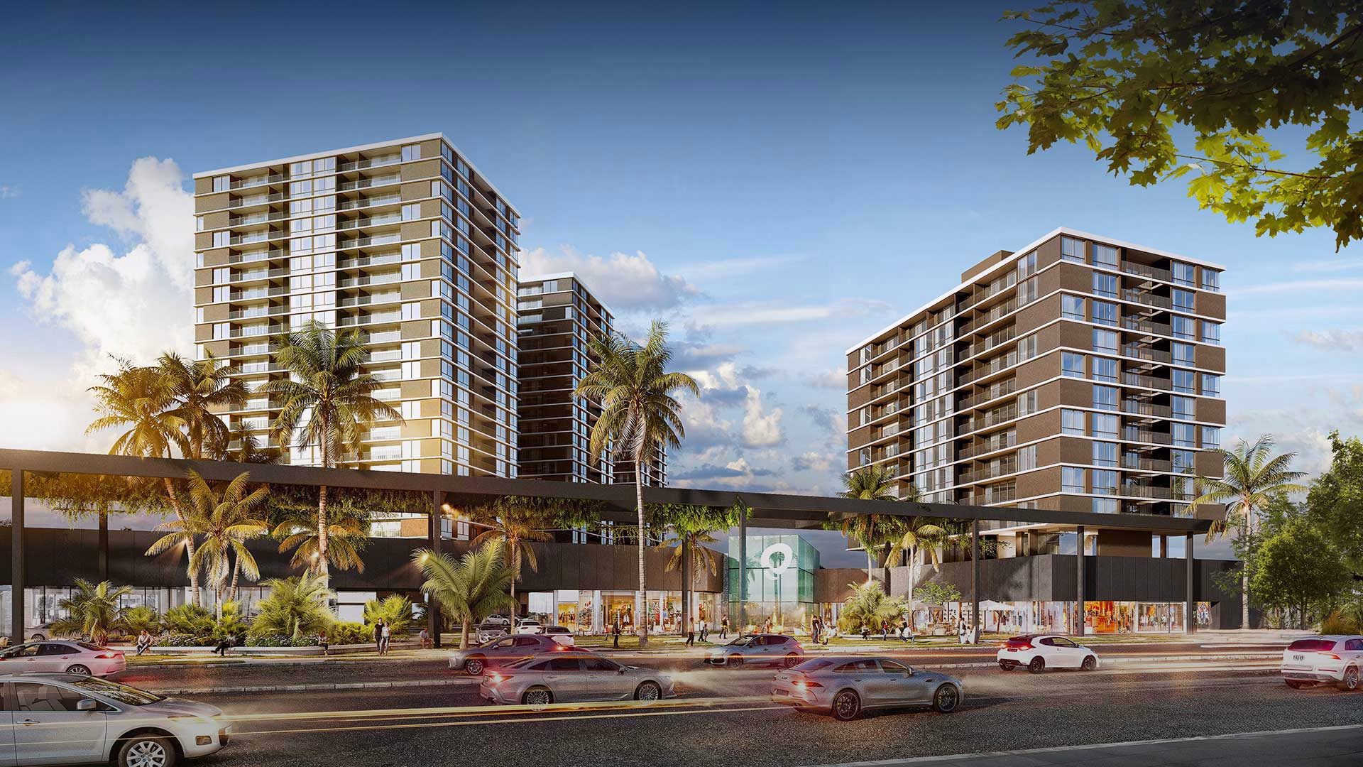 Render del exterior de Aventura Shopping al atardecer, con la caja de vidrio verde y la marca iluminada